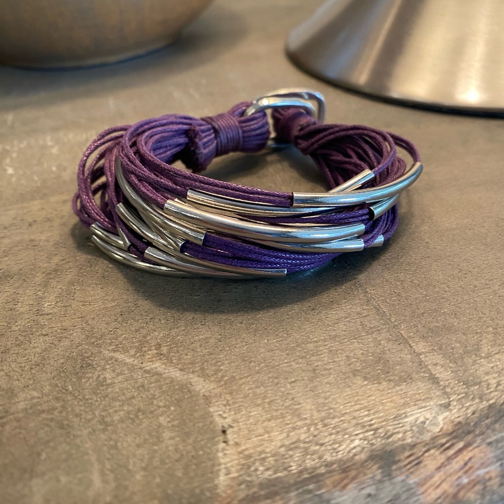 Bracelet made of purple cord with silver accent beads